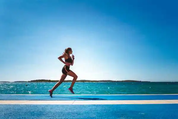 Woman running showing strong leg muscle Swadlincote